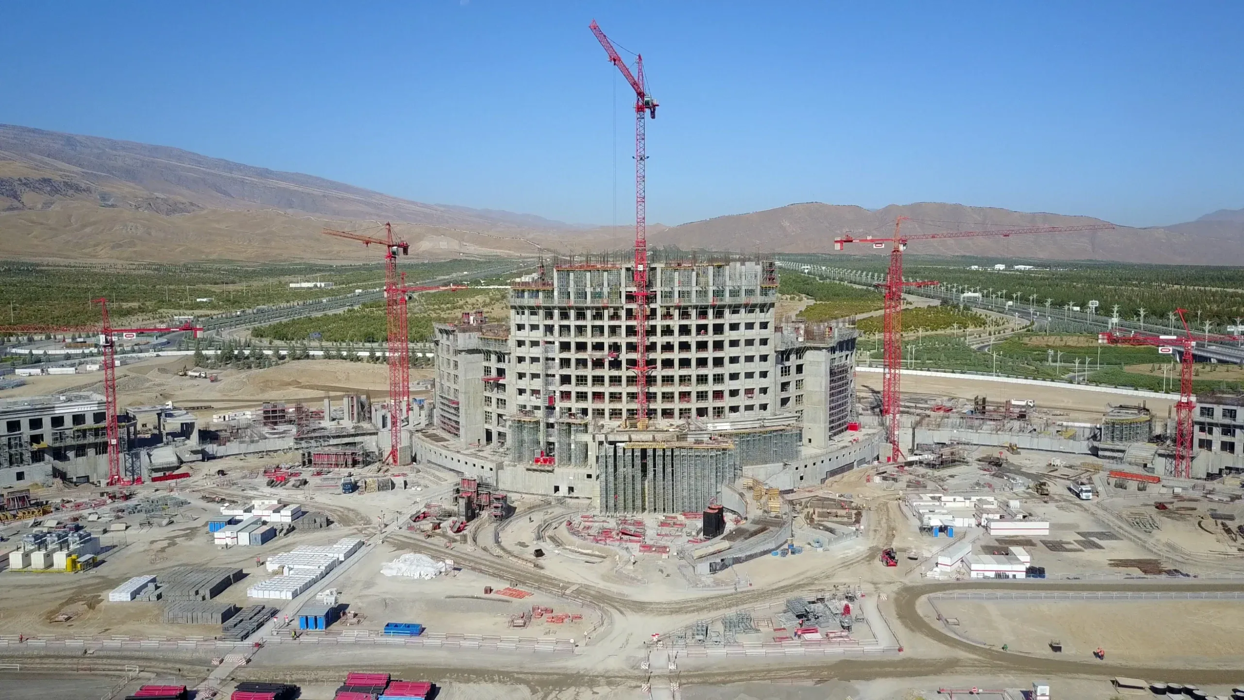 Aerial view of the Arkadag hotel under construction in Turkmenistan, ringed by tower cranes