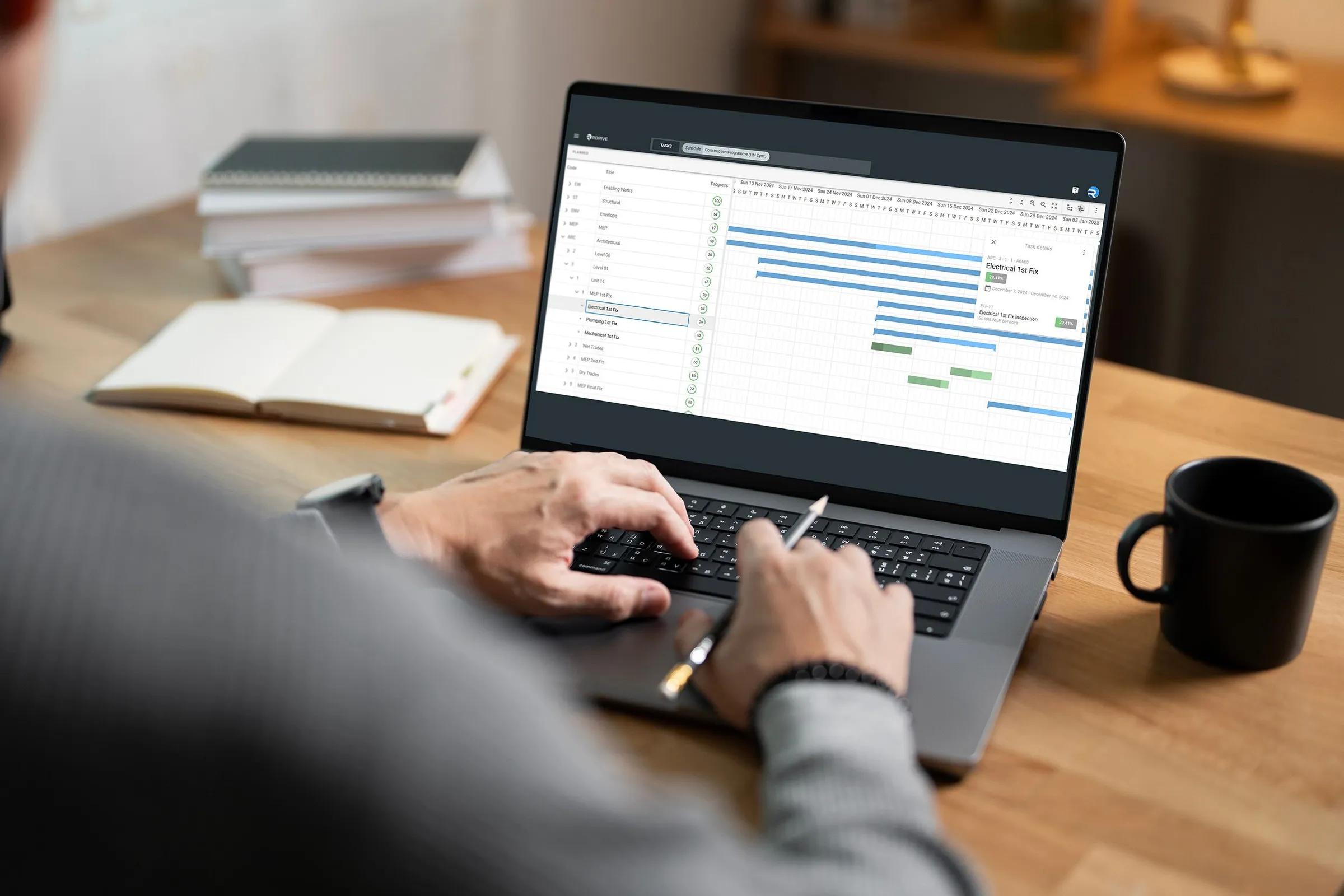 Project manager working through a programme schedule on a laptop in RDrive Progress Monitoring