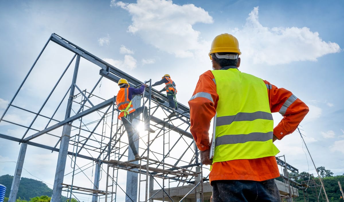 Supervisor overseeing workers on a steel frame, where records are captured against their location